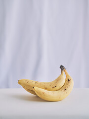 Ripe Bananas on White Table in Soft Light