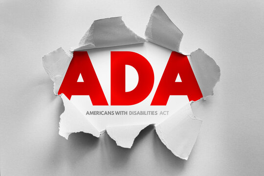 ADA acronym in bold letters revealed through torn paper, representing the Americans with Disabilities Act. Symbolic image for accessibility, disability rights, equality, and inclusion
