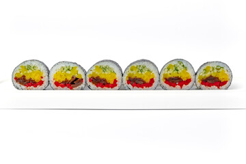 Sushi roll mix on a white dish on a white background isolated