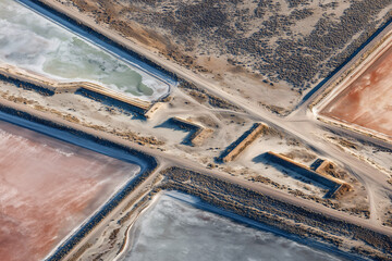 Aerial Mosaic Of Pipeline Network Feeding Lithium Ponds, Serpentine Pipes Over Levees, Meter Stations And Valves, Varied Brine Hues By Stage, Arid Sagebrush Fringe, Precision Engineering