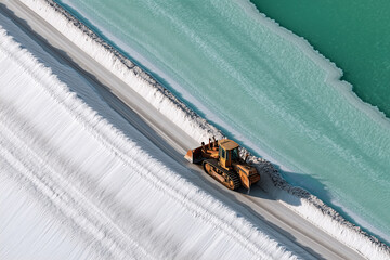 Close Top-Down Of Salt Harvesting At End Pond, Bulldozer Pushing Crystalline Layers, Mint-Green Brine And White Crust, Tire Patterns, Industrial Detail, Nevada Lithium Works
