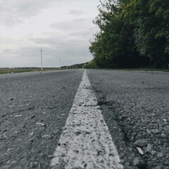 Close-up of a white stripe on an asphalt road