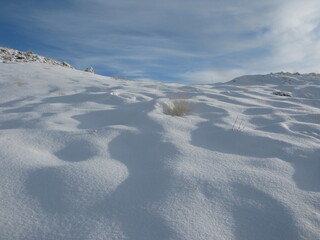 snow covered mountains in winter.A majestic white mountain covered with snow,blending forest beauty and the spirit of high altitude adventure.