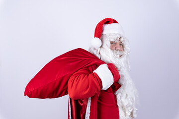 Santa Claus cheerfully holding a bag of gifts