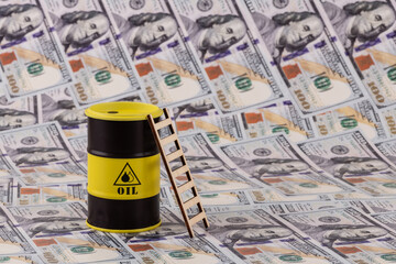 A barrel of petroleum products against a background of $100 bills.