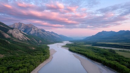 Dramatic Aerial Landscape of a Winding River Valley Surrounded by Majestic Mountains Under a Soft Pink and Blue Sunset Sky with Wispy Clouds