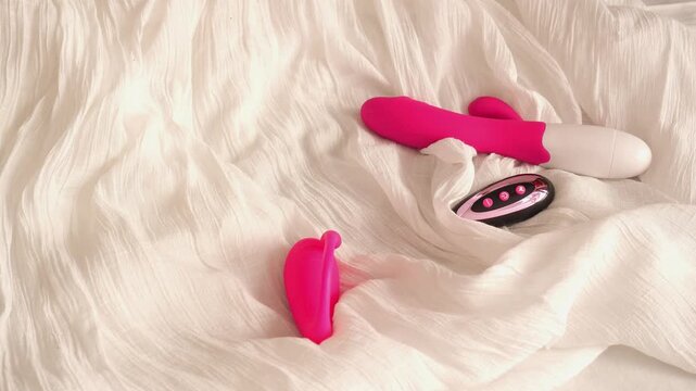 Woman in black transparent glove takes pink vibrators and anal beads. BDSM erotic set. Adult toys. Vibrator, vacuum vibrator, dildo, anal beads