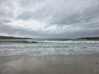Wave breaking on open beach under cloudy sky, Isle of Lewis, Outer Hebrides, Scotland