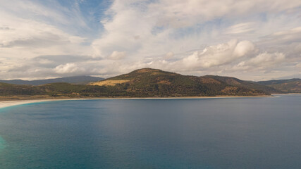 Fototapeta premium Panoramic drone view of Lake Salda: White shoreline, turquoise waters, and surrounding hills. The vastness and beauty of nature.