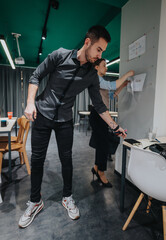 Business team members actively collaborate in an office setting, brainstorming and discussing ideas...