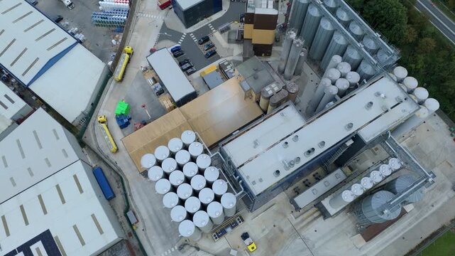 Aerial view of an industrial area featuring silos, buildings, and vehicles, creating a stark contrast between metal and concrete, Goole, England, United Kingdom.