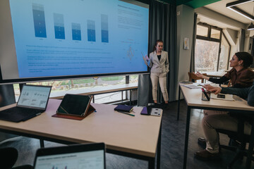 A group of business people during a professional presentation highlighting data on a screen. This...