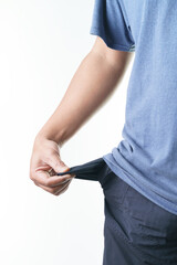Man sadly pulls out empty pocket showing financial trouble and economic hardship during recession times