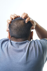 Man scratching scalp aggressively due to itchiness or irritation, addressing hair care concerns and seeking relief from discomfort