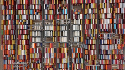London, United Kingdom - 11 October 2025: Aerial view of stacked shipping containers creating a vibrant mosaic of colors and textures in a storage yard. - Powered by Adobe
