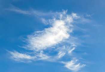 Beautiful cloudscape of nature several white clouds on blue sky background in daytime. Fabulous swirling water vapors. Multi-tiered clouds of steam.