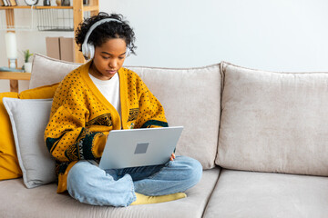 African american girl using laptop at home office looking at screen typing chatting reading writing email. Young woman having virtual meeting online chat video call conference. Work learning from home
