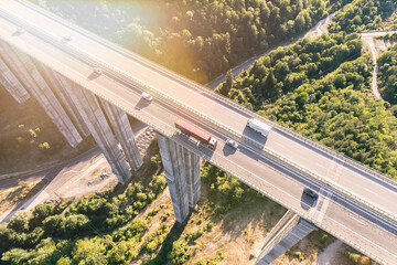  cargo delivery trucks drive on highway aerial top view
