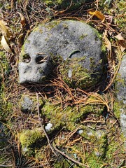 Detail of an ancient gravestone depicting a carved skull.