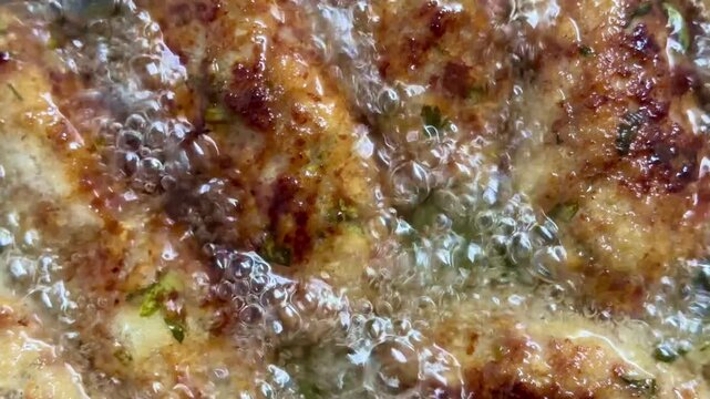 Close-up of raw meatballs being deep-fried. Traditional Cypriot food, Mediterranean cuisine.