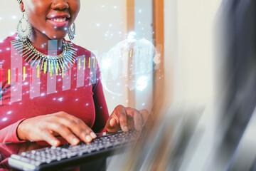 Woman using a computer with data visualization in a modern workspace, focusing on digital information and analysis