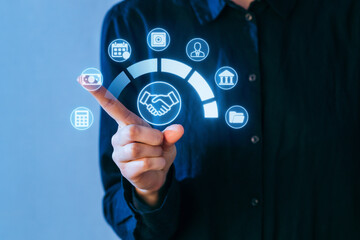Person interacts with digital icons representing finance, banking, and business solutions in a modern workspace