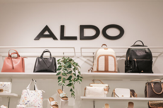 Aldo handbags and backpacks displayed on shelves in store