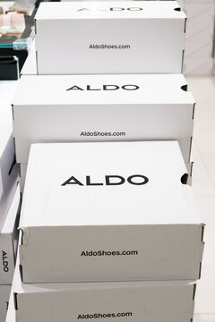 Aldo shoe boxes stacked in store, plain white design with logo