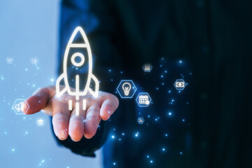 Innovative technology concept with a glowing rocket symbol in a hand surrounded by digital icons