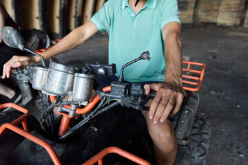 A skilled rider navigating an ATV in an expansive and abandoned warehouse setting