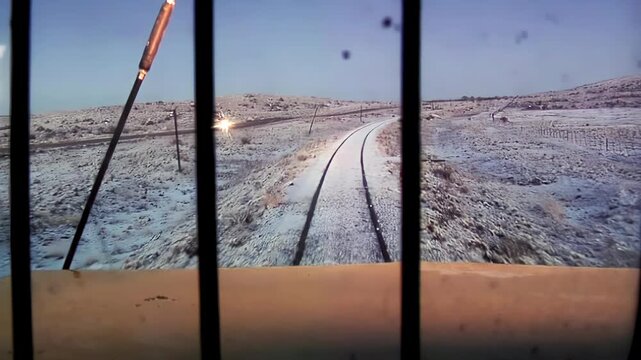Railway View at Twilight With Snow-Covered Terrain and Car Headlight, Patagonia, Argentina - 4K