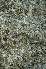 Weathered Stone Wall Texture Showing Cracks and Natural Vertical Patterns