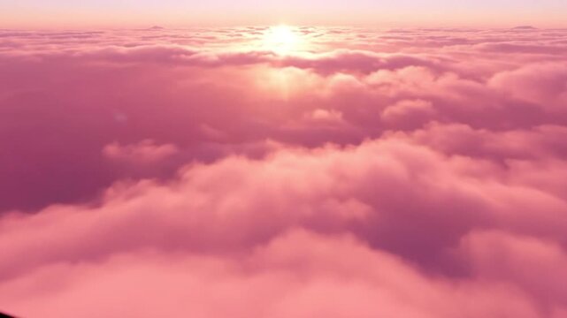 Sunrise above a sea of pink clouds, golden sun rays breaking through the fluffy formations