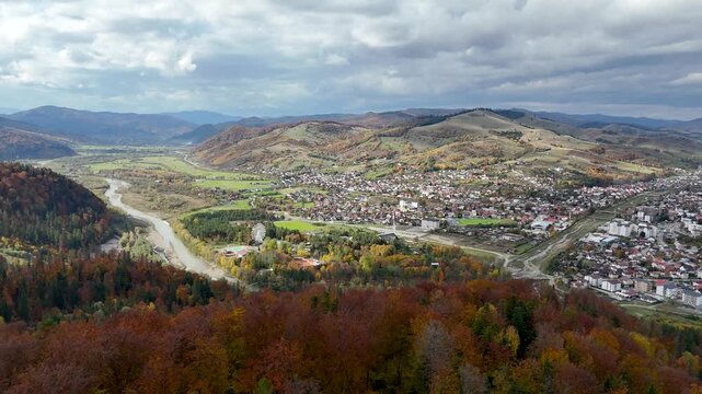 Drone shot of Gura Humorului city in autumn season with Arinis Park and Moldova River
