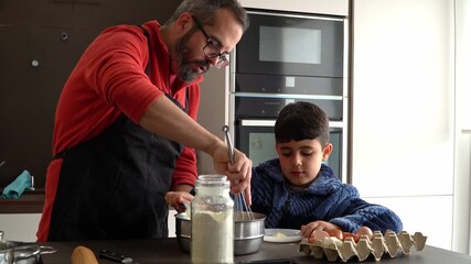 Father and son cooking together at home kitchen - Powered by Adobe