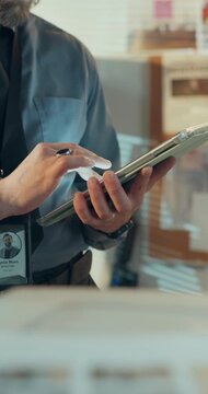 Hands, person and detective with tablet in office for research, investigation and evidence report. Man, name tag and digital for witness statement, crime scene information and trace of online footage