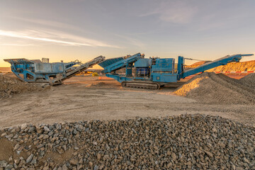 Heavy and mobile machinery in a quarry to transform stone into construction material