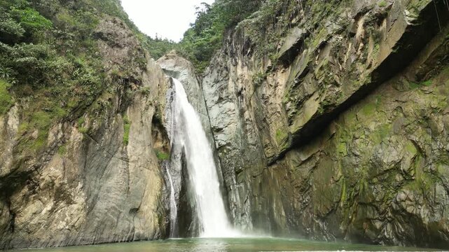 Beautiful aerial footage of waterfall and green forest landscape &mdash; cinematic nature scene for documentaries or tourism videos