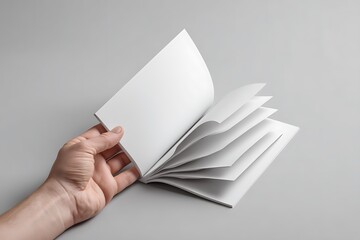 A mockup of a hand holding a blank white magazine, with a clear cover template, offering a clean and professional design layout for promotional use.