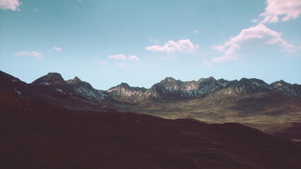 Snow capped peaks rise dramatically against a clear azure sky. The serene landscape reflects the beauty of nature, capturing a moment of peaceful solitude in a stunning wilderness.