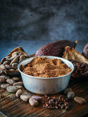 Close-up of Natural cocoa powder with brown cocoa beans and dry cacao nibs