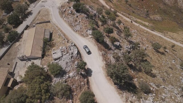 Road trip in Greece &ndash; car on twisty road above the sea
