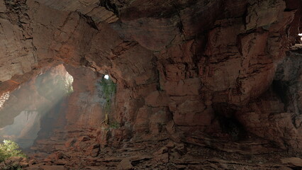 This stunning cave showcases textured red rock formations illuminated by soft rays of sunlight. Lush greenery peeks through the natural openings, creating a mystical atmosphere.