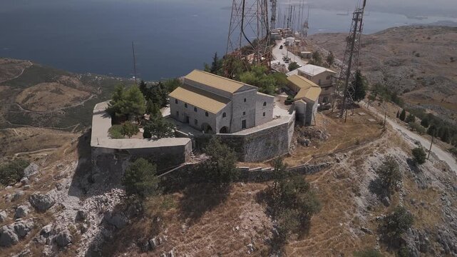 Summer drone video of seaside village in Greece. Church, Monastery