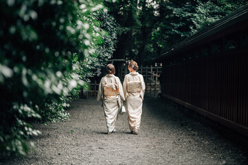 Two Women in Kimono Walking Together at a Peaceful Shinto Shrine Path in Tokyo