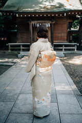 Woman Wearing Kimono Standing in Front of a Shinto Shrine Torii Gate in Tokyo, Japan