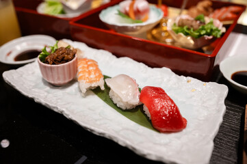 Assorted Sushi and Japanese Side Dishes on Elegant Ceramic Plate – Traditional Japanese Cuisine Presentation