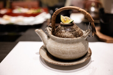 Traditional Japanese Teapot with Kabosu Garnish – Rustic Ceramic Dobin for Tea or Broth Presentation