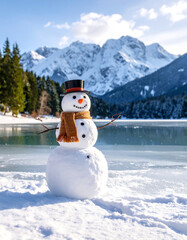 Obraz premium Snowman on frozen lake with mountains backdrop festive winter scene