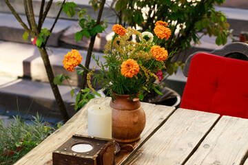 marigold flower vase decorative elements on table restaurant patio space in spring season bright colorful blossom day